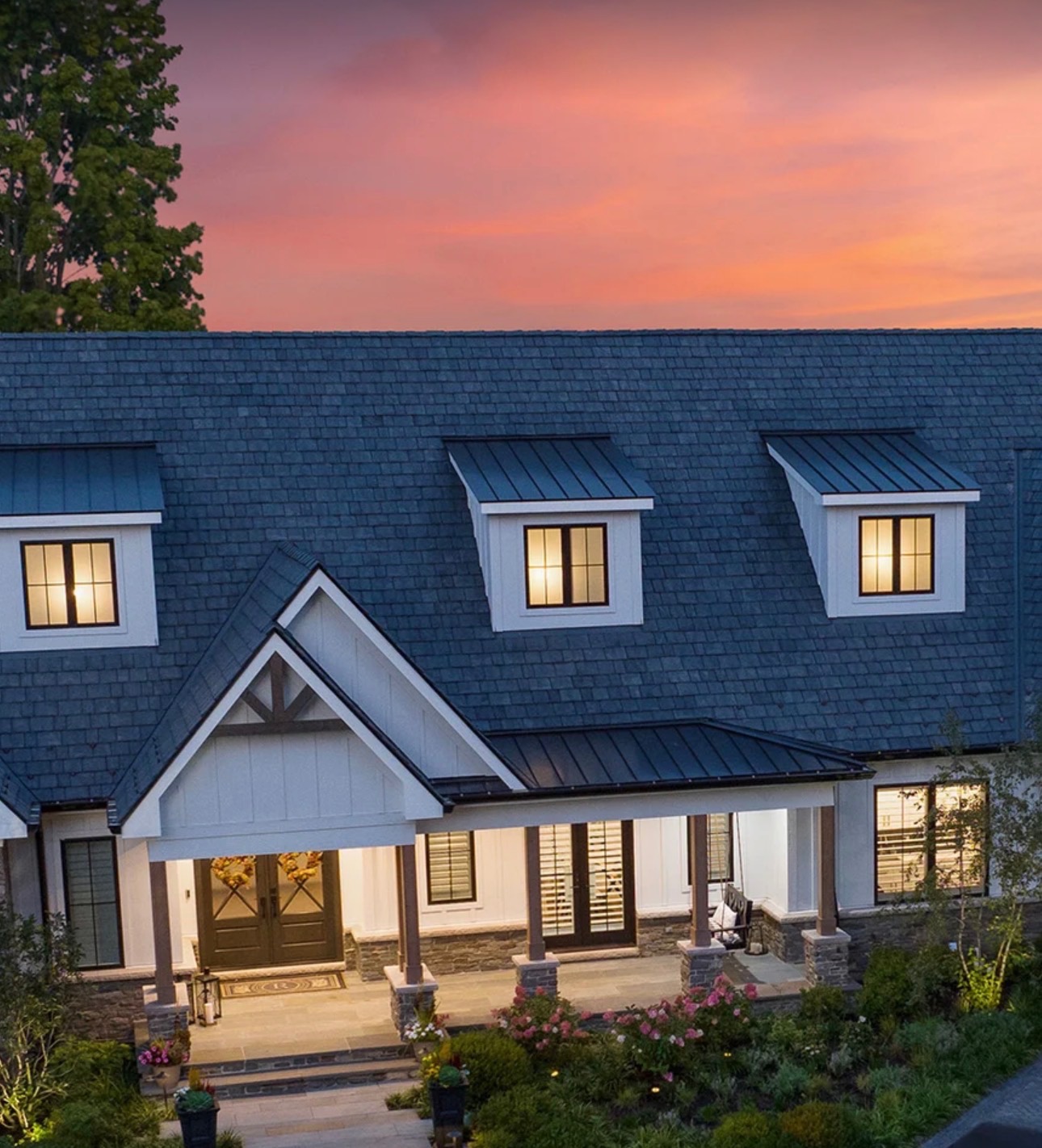 Modern farmhouse-style home with quality exterior craftsmanship at dusk — Homemasters
