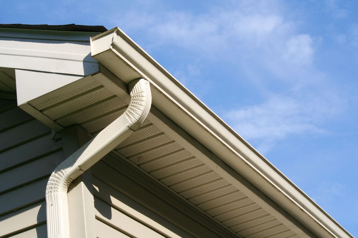 Seamless gutter and downspout detail at the eave of a home