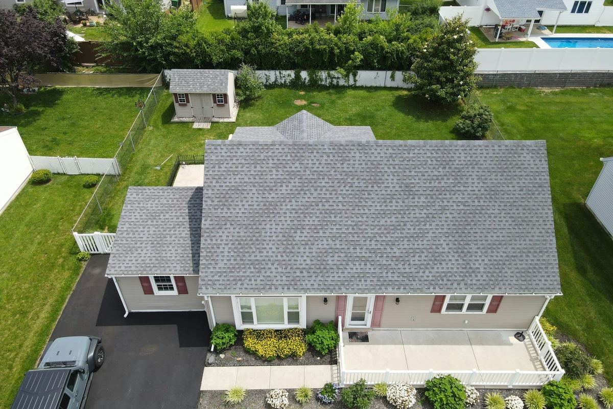 Aerial view of a completed architectural shingle roof on a single-family home