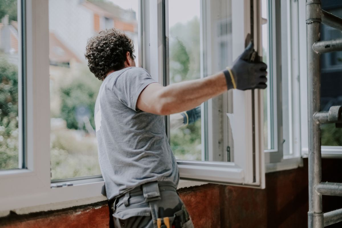 Installer setting a new energy-efficient replacement window